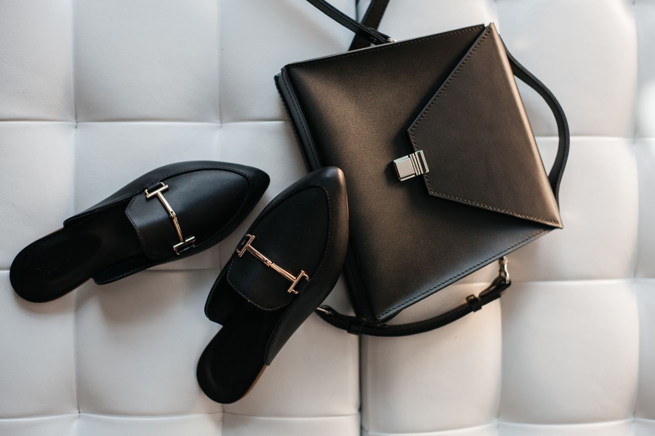 services-01 Elegant black leather handbag and shoes displayed on a stylish white background.